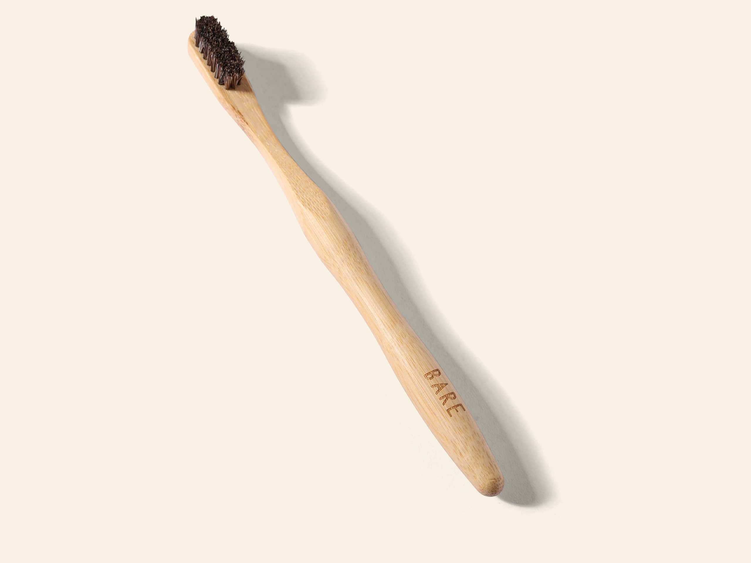 The BARE toothbrush laid on warm cream