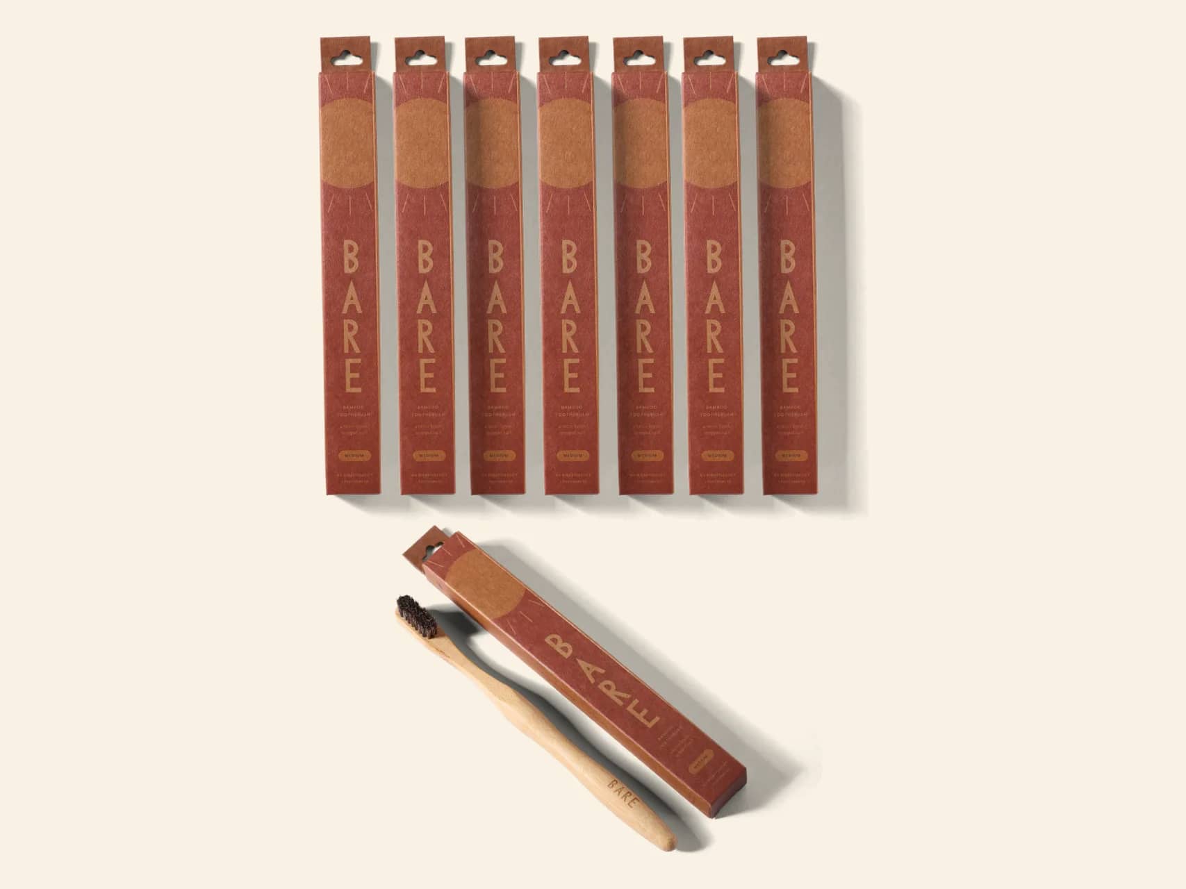 The BARE eight pack: seven sealed packs in a row and one opened beside its brush