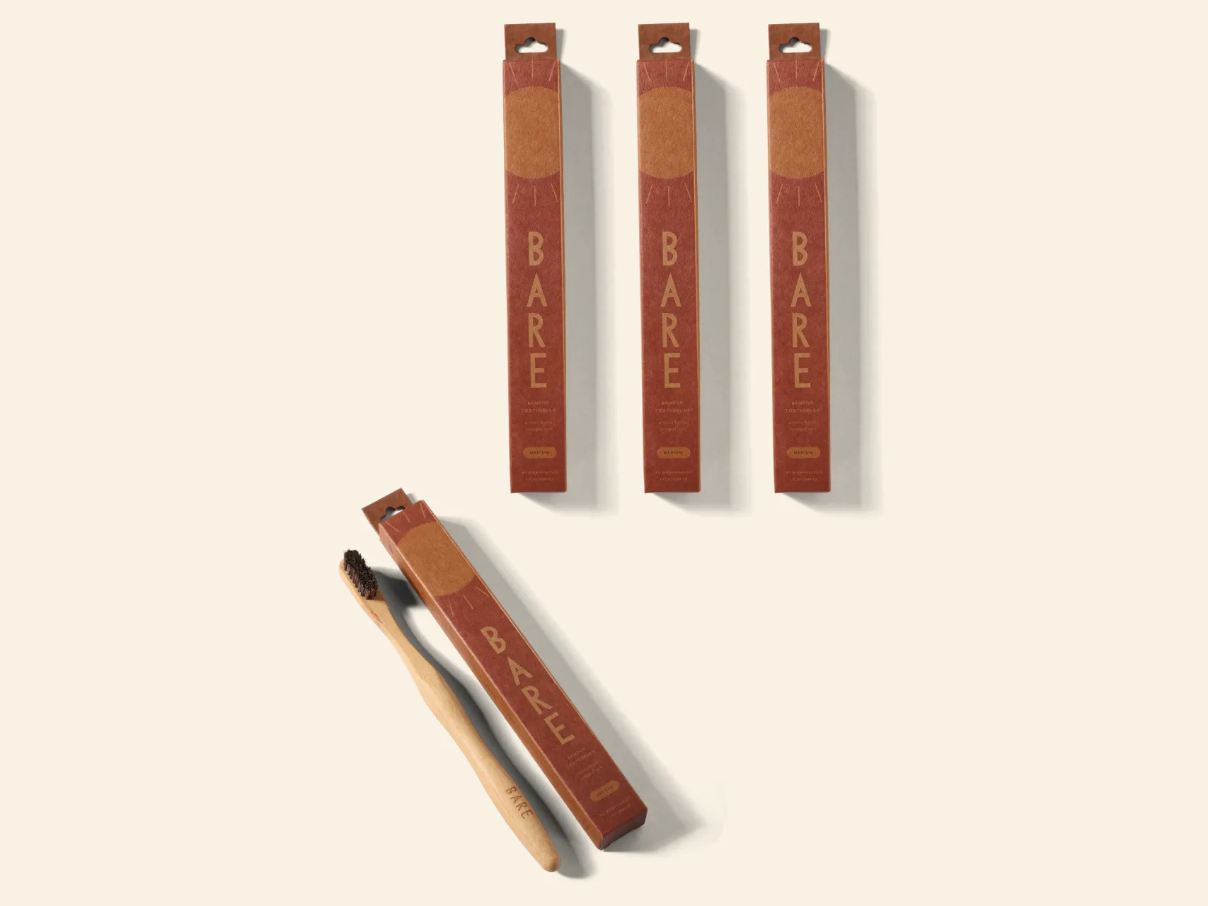 The BARE four pack: three sealed packs and one opened beside its brush